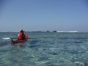 Lucy paddling out to the wreck on the reef lighthouse reef